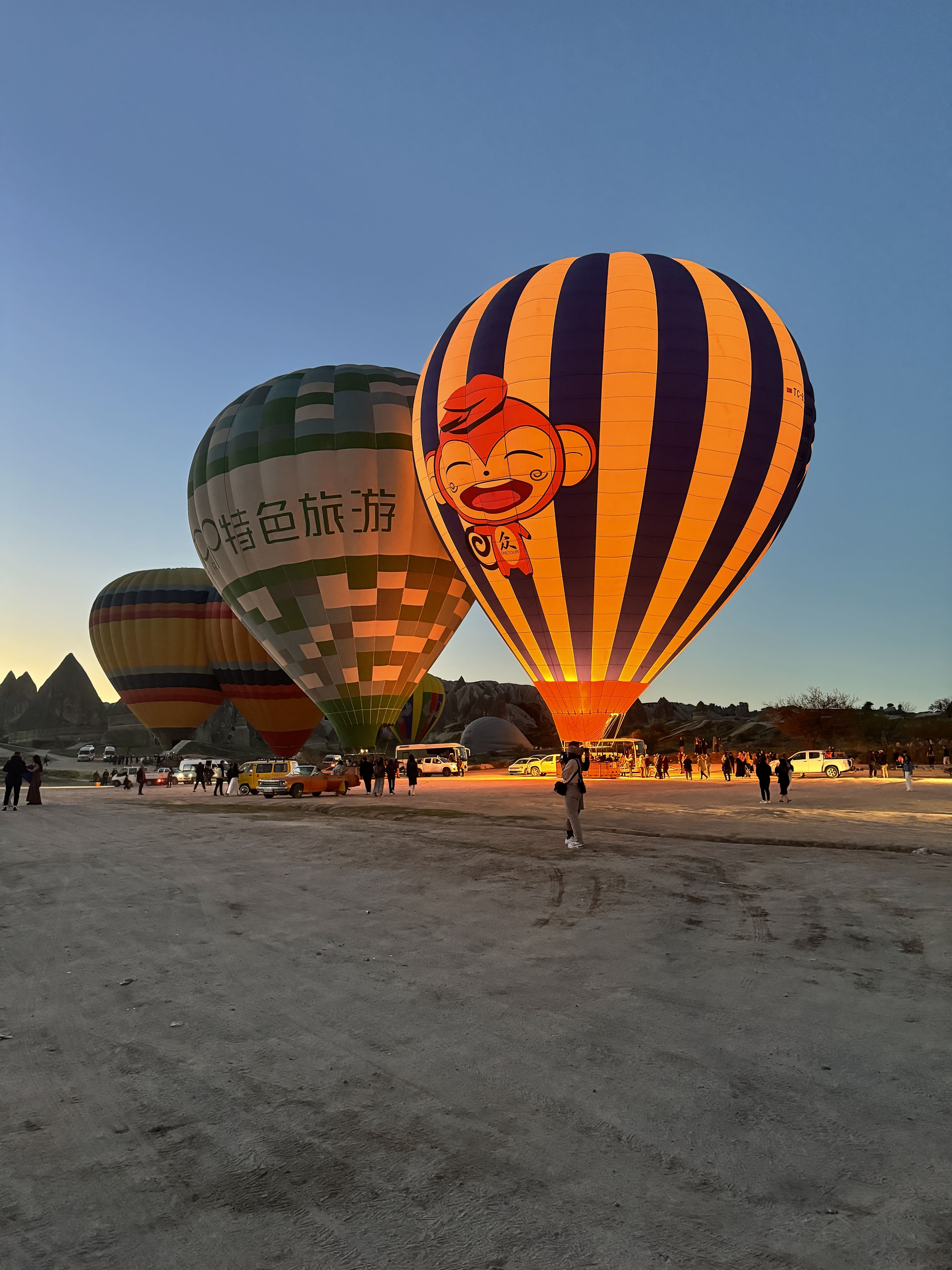Hot air balloons inflating at dawn Cappadocia