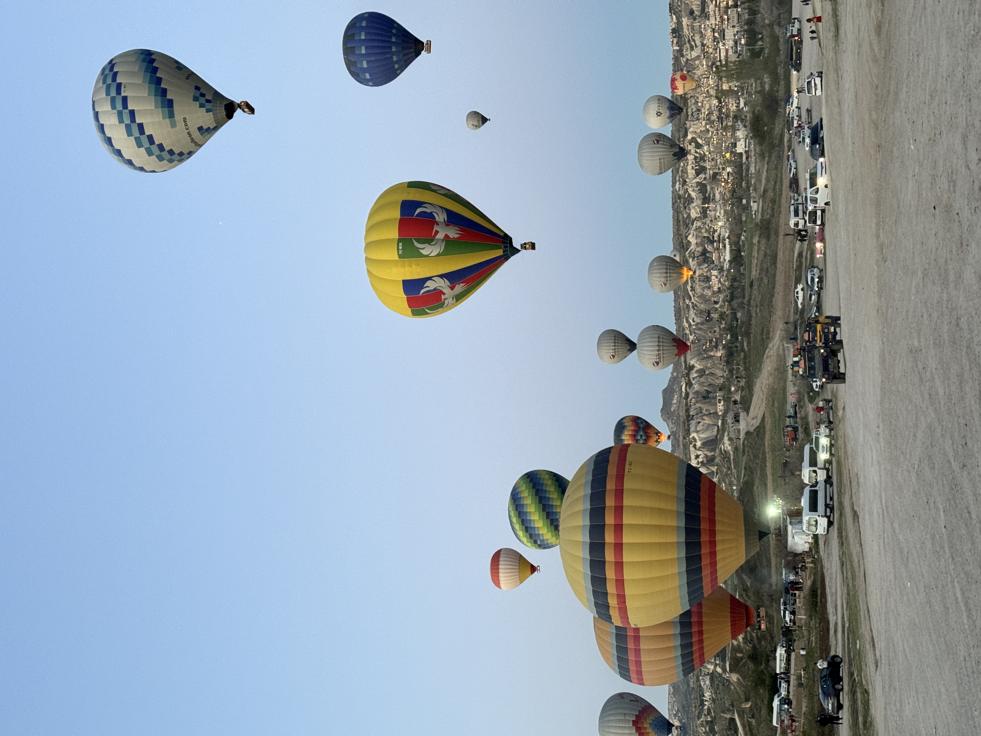 Many hot air balloons over Cappadocia at sunrise