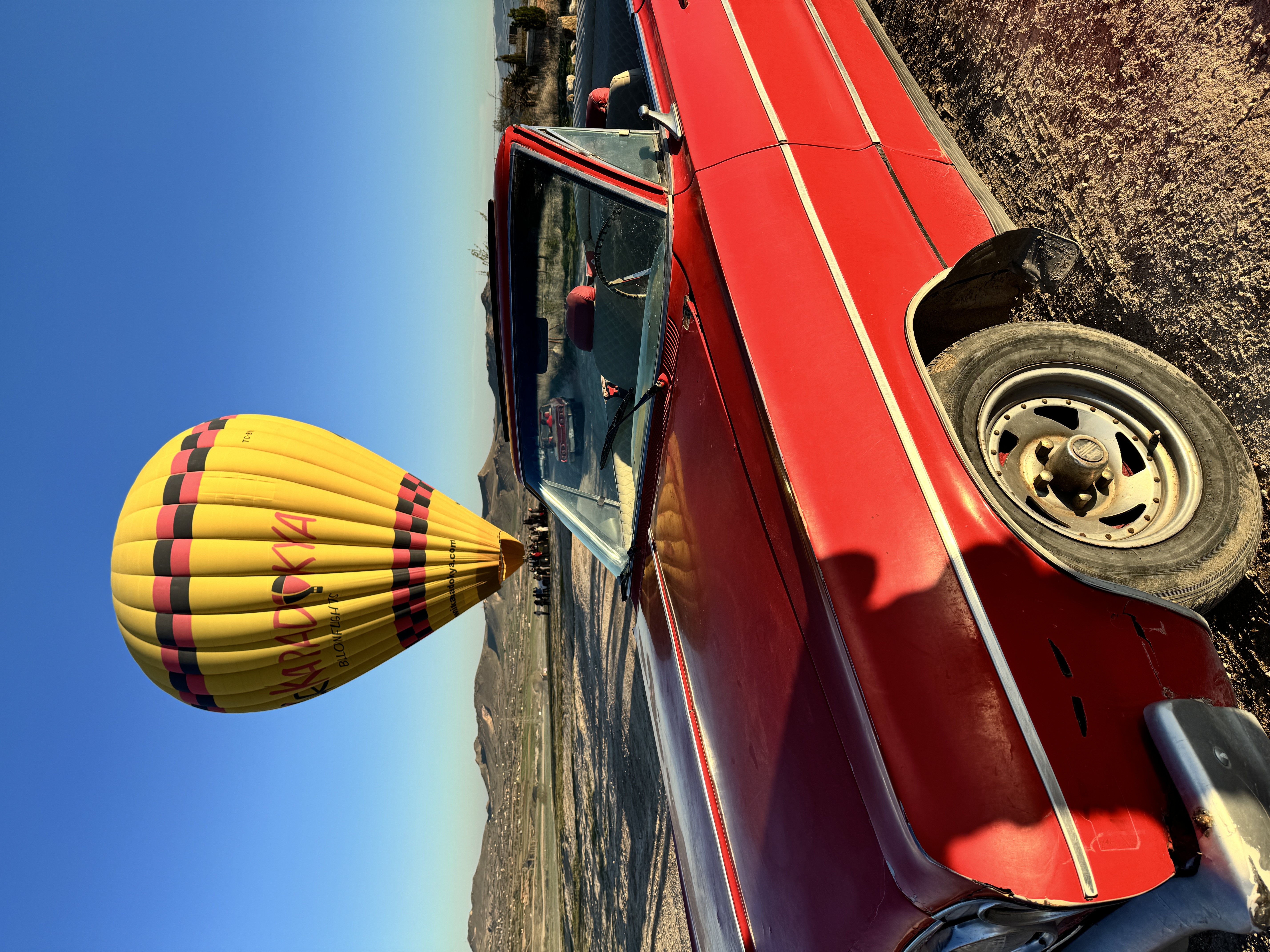 Red vintage car hot air balloon Cappadocia